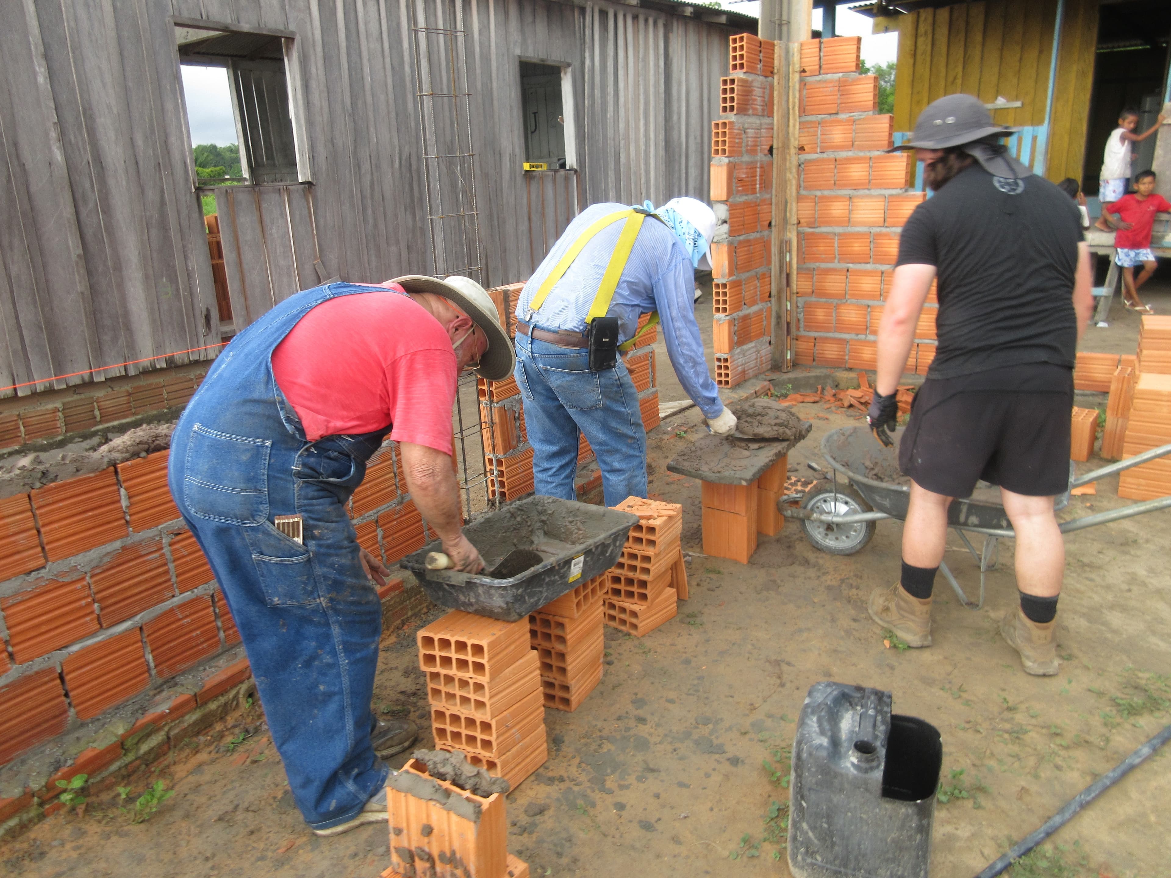 Volunteers laying bricks