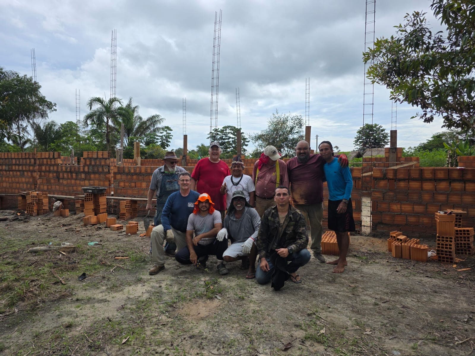 Group posing in front of brick structure