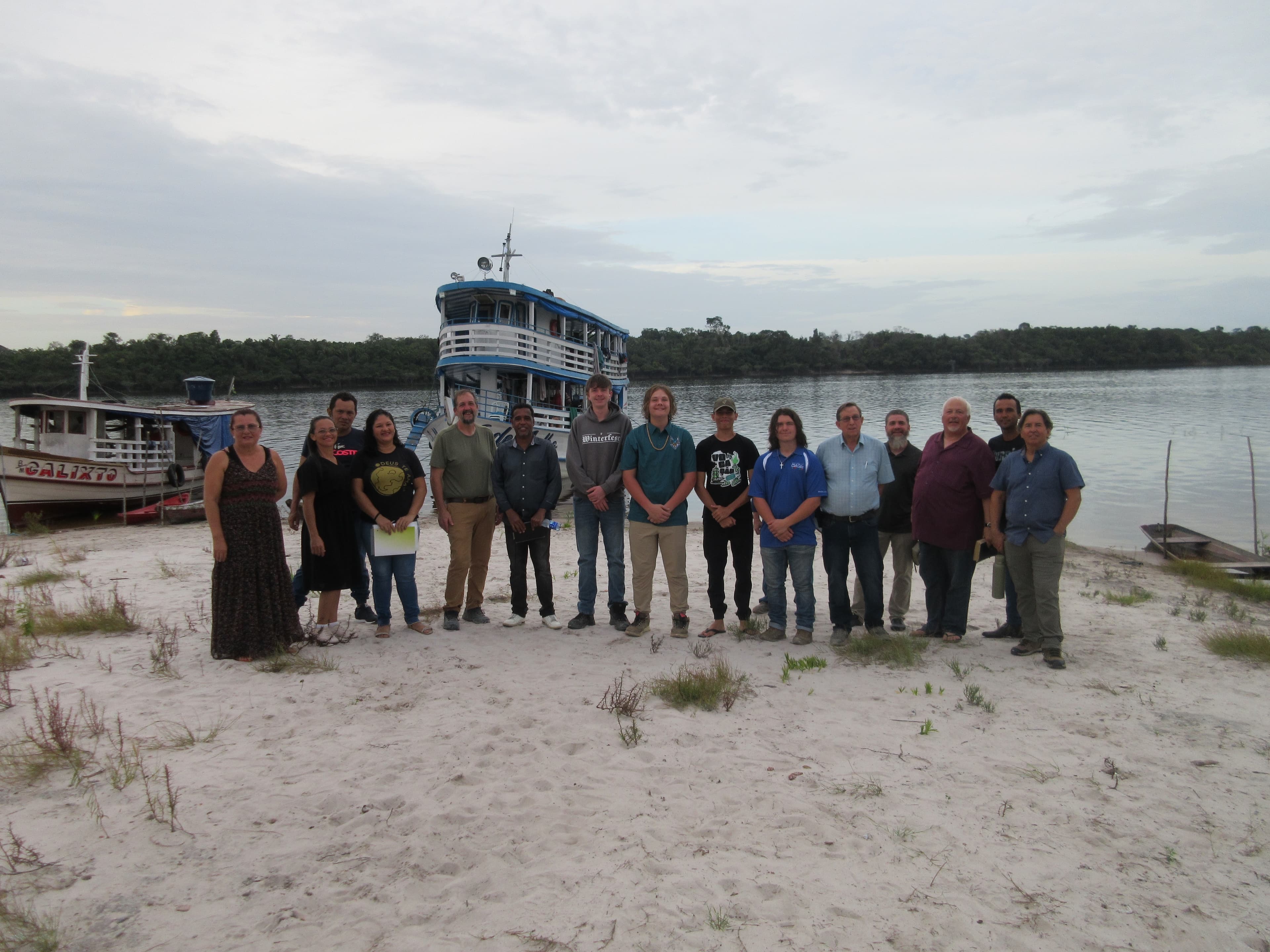 Team by the river with boats